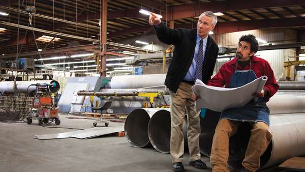 two men looking at business plans